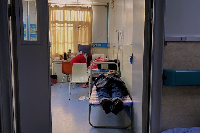 <p>A patient with Covid-19 rests on a bed at Tangshan Gongren Hospital in China's northeastern city of Tangshan</p>