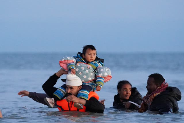 <p>A group of people thought to be migrants wade into the sea near Gravelines in France</p>