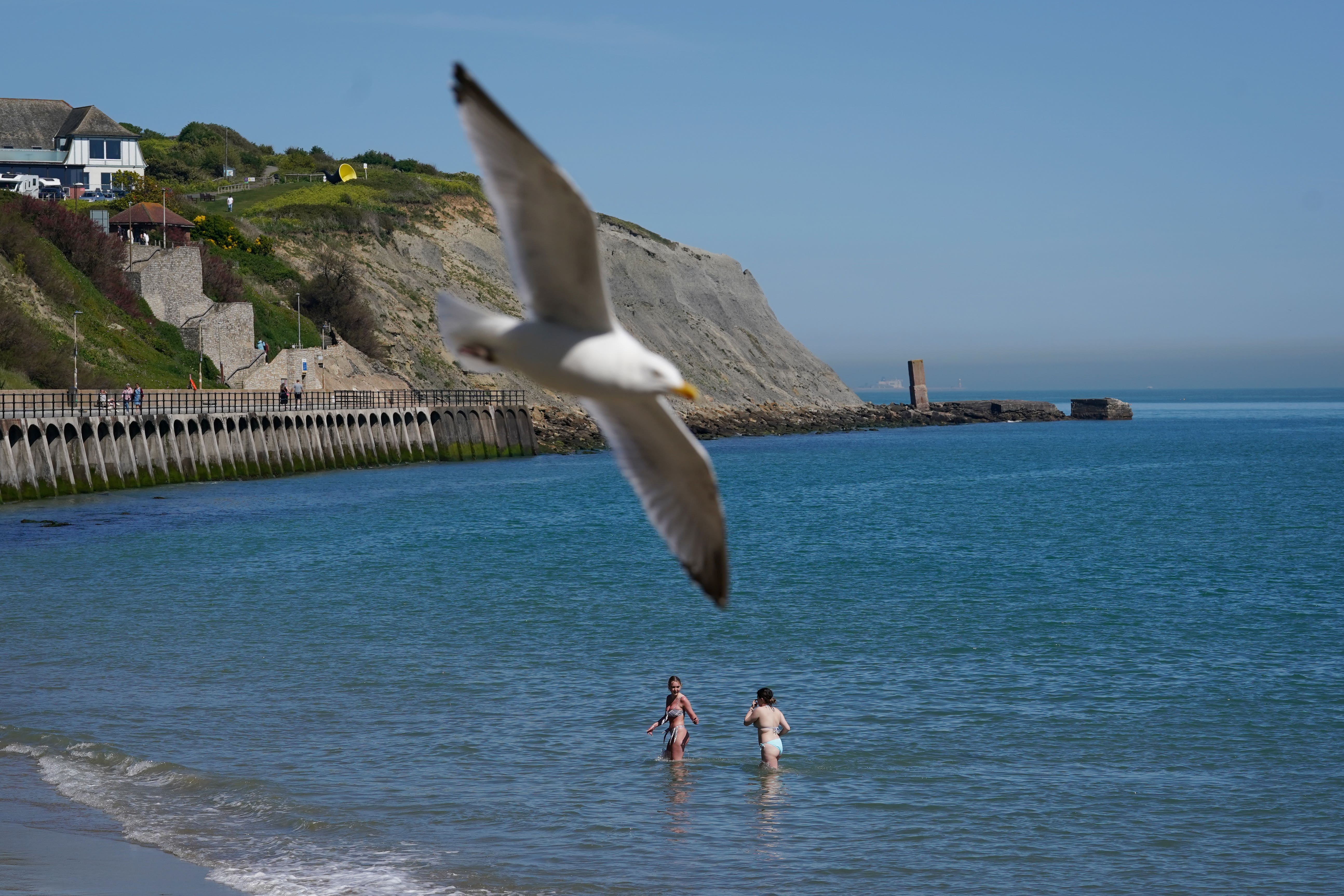 Two women cool off in the sea in Folkestone, Kent (Gareth Fuller/PA)