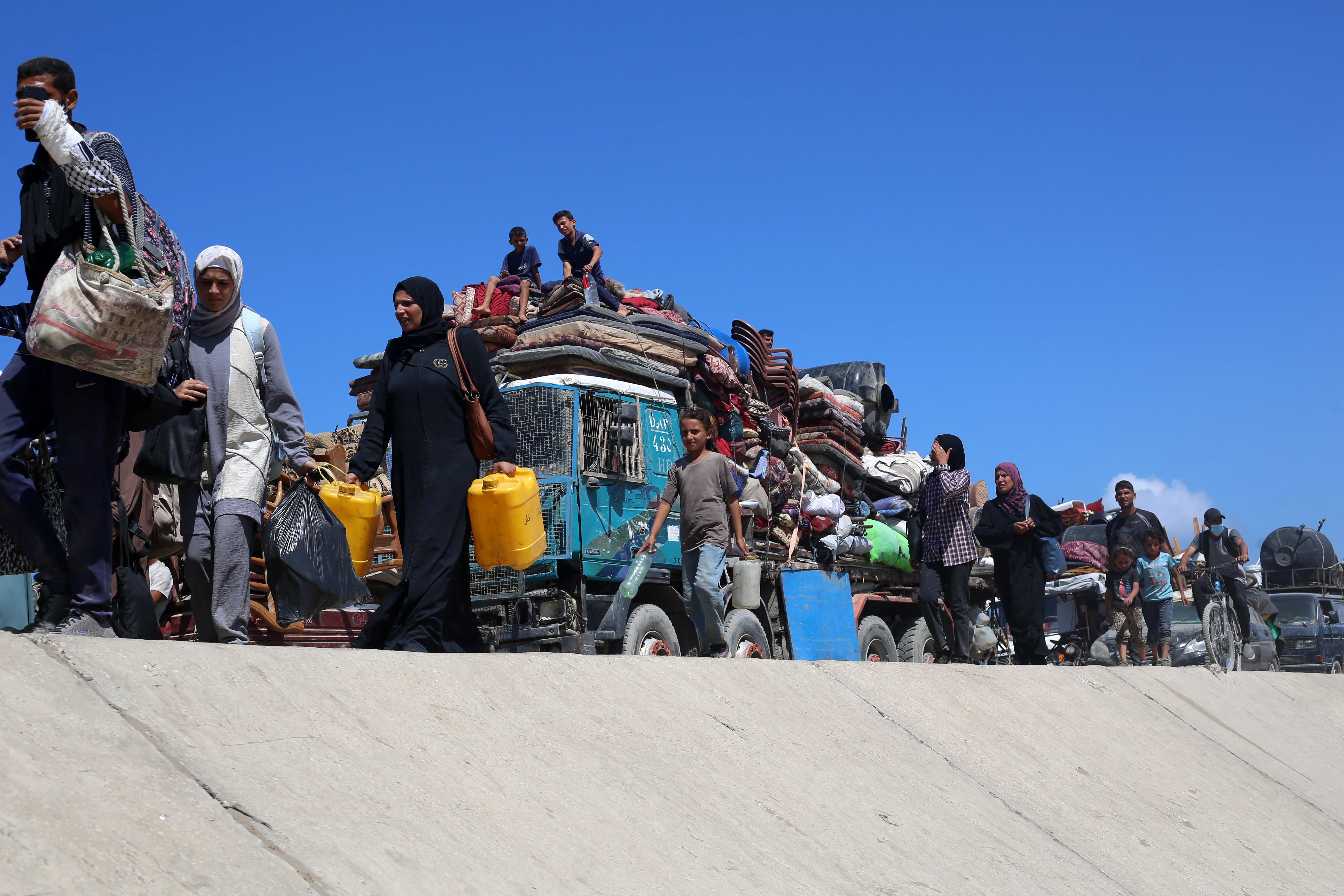 <p>Palestinians from Gaza City flee south on the coastal road near the Nuseirat refugee camp on 19 September 2025</p>
