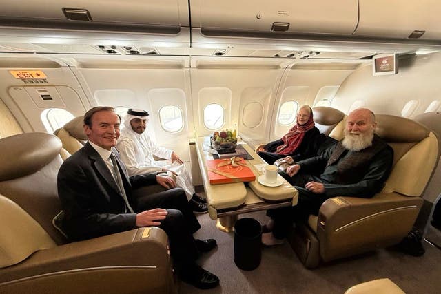 Barbie and Peter Reynolds, right, sitting opposite UK and Qatari diplomats on a plane (Qatar Foreign Ministry via AP)