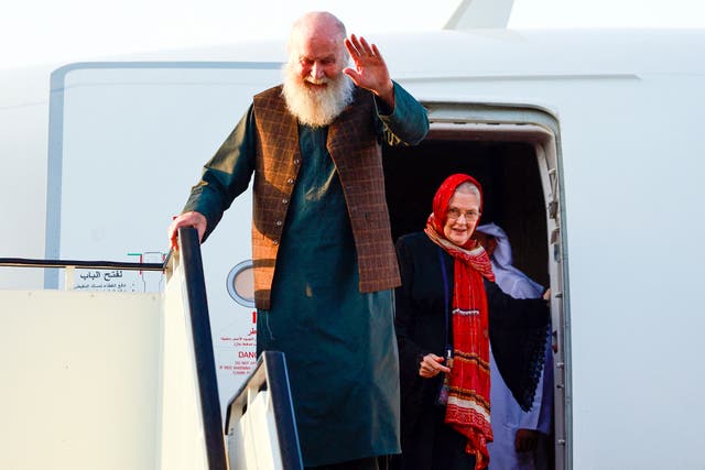<p>‘We are just very thankful’: Peter and Barbie Reynolds after landing at the airport in Doha on Friday</p>