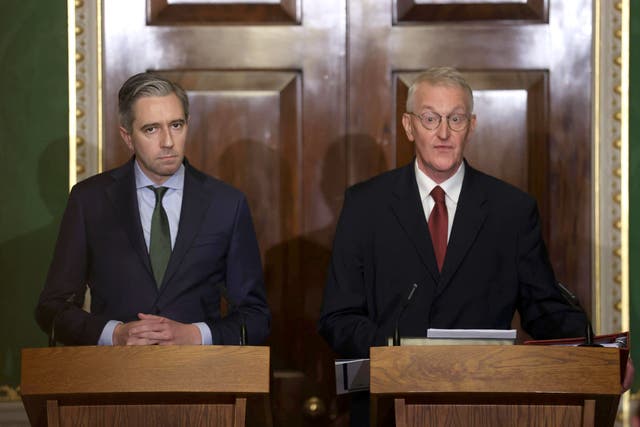 Tanaiste Simon Harris (left) and Northern Ireland Secretary Hilary Benn speak to the media in the Throne Room at Hillsborough Castle, Belfast, following the publication of a new joint framework to deal with the legacy of the NI Troubles (PA)