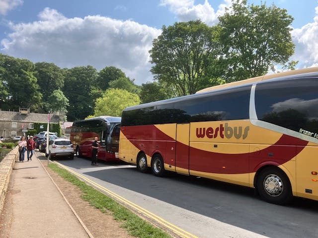 <p>Coaches fill the main road through Bibury on a busy day for the village in June. Parish council chairman Craig Chapman wants a ban on coaches.</p>