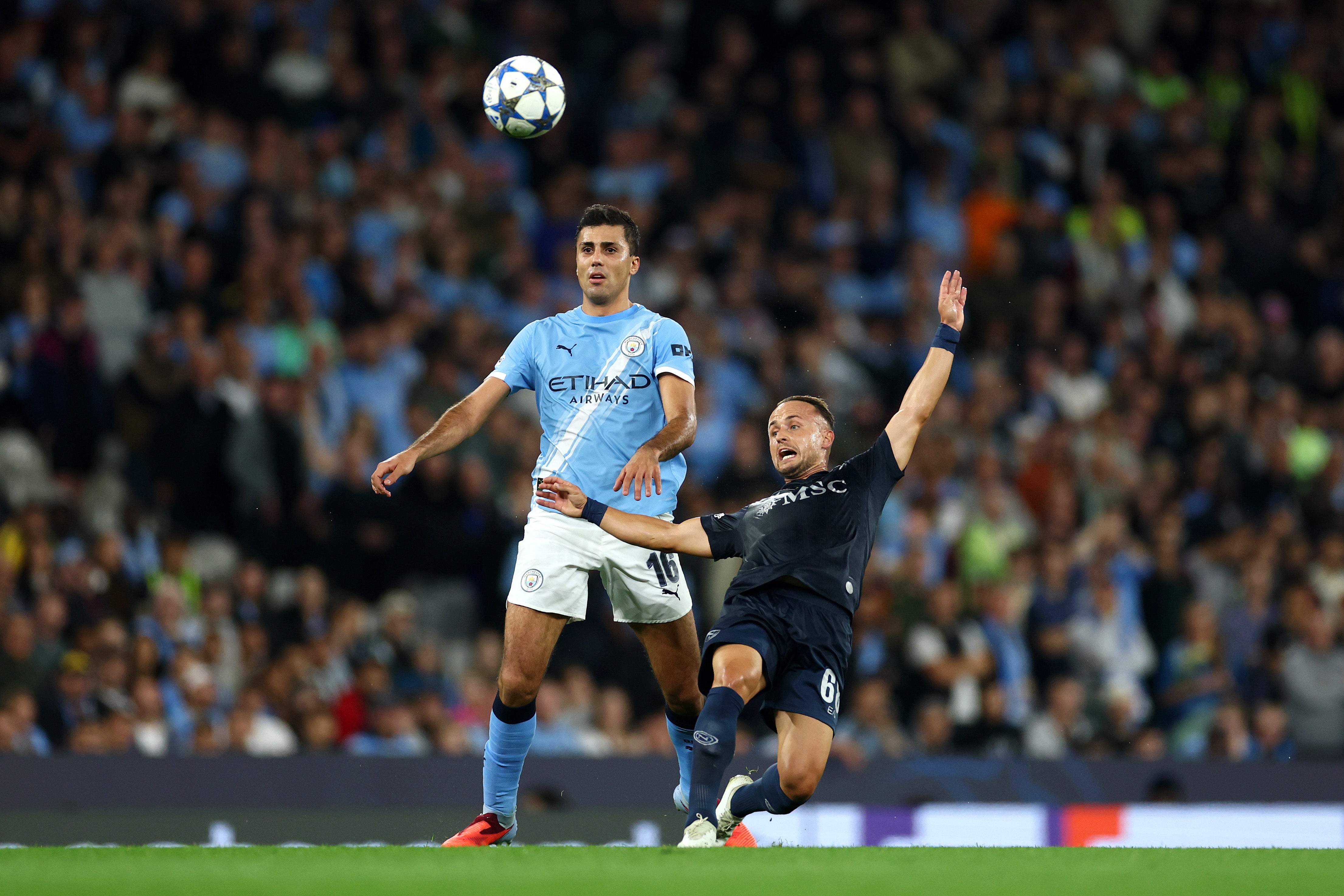 Rodri of Manchester City watches the ball as Stanislav Lobotka of Napoli