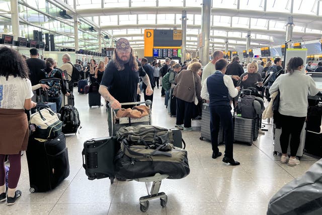 People at London Heathrow Airport, after flights were delayed following an alleged cyber attack targeted a service provider for check-in and boarding systems (Maja Smiejkowska/PA)