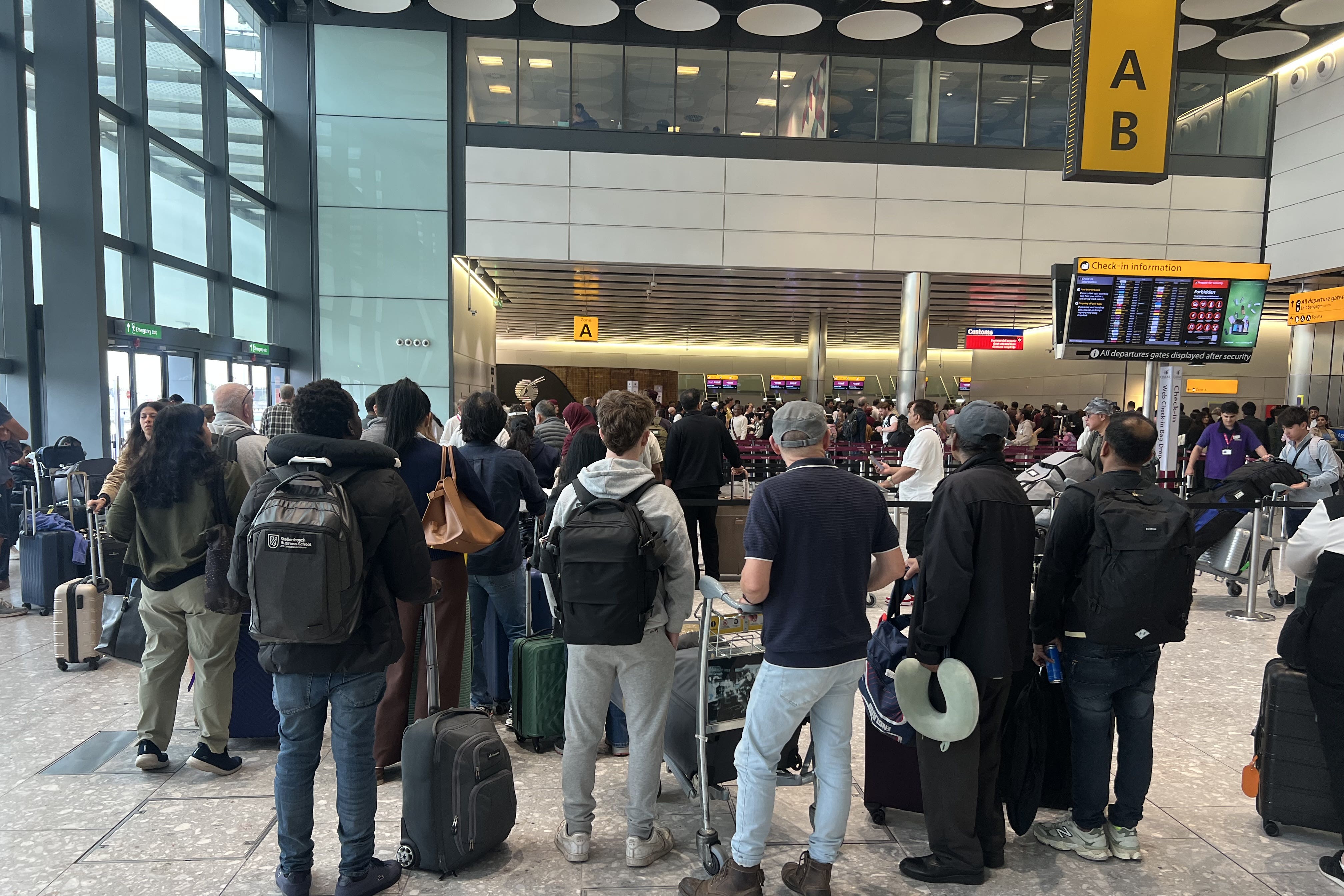 People at T4 at Heathrow Airport after flights were delayed and cancelled at airports including Heathrow after an alleged cyber attack targeted a service provider for check-in and boarding systems (Maja Smiejkowska/PA)
