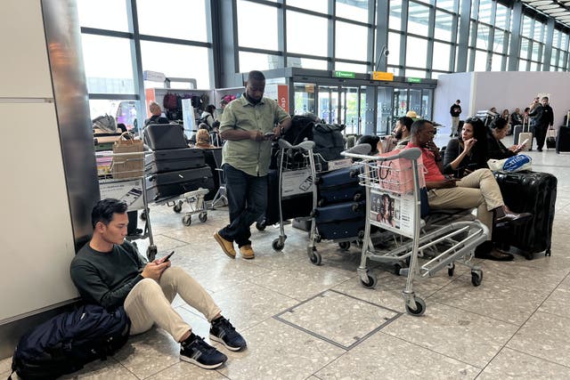 <p>People at T4 at Heathrow Airport after flights were delayed and cancelled at airports including Heathrow after an alleged cyber attack targeted a service provider for check-in and boarding systems (Maja Smiejkowska/PA)</p>