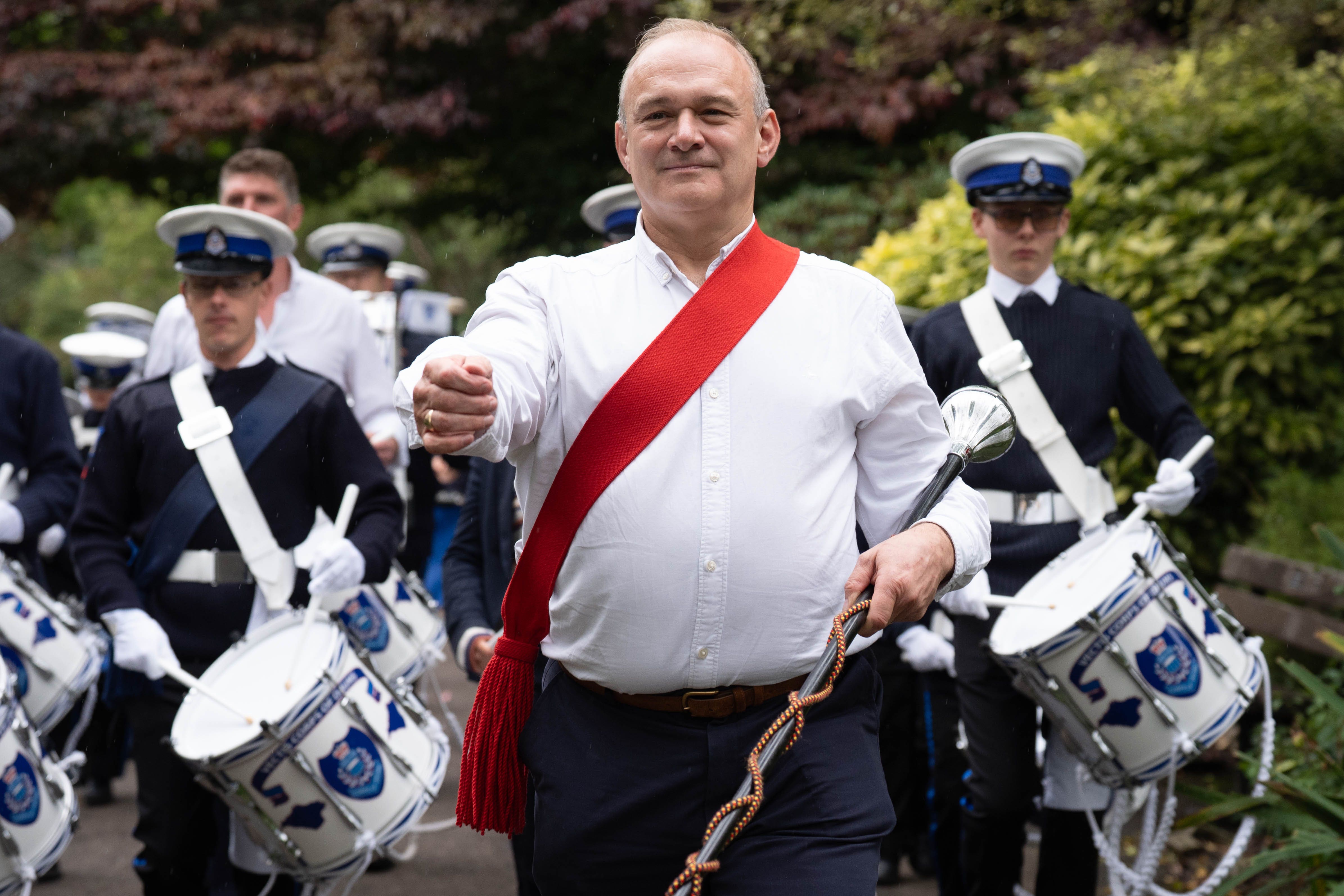Liberal Democrat leader Sir Ed Davey arrives at the Liberal Democrats’ autumn conference, at the Bournemouth Conference Centre in Dorset with members of the Vectis Corps of Drums, from the Isle of Wight (Stefan Rousseau/PA)