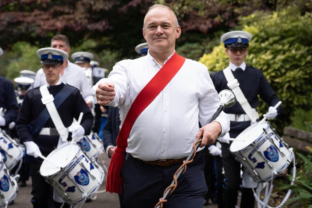 Liberal Democrat leader Sir Ed Davey arrives at the Liberal Democrats’ autumn conference, at the Bournemouth Conference Centre in Dorset with members of the Vectis Corps of Drums, from the Isle of Wight (Stefan Rousseau/PA)