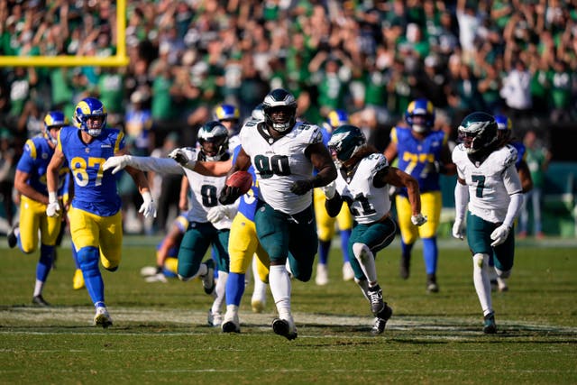 Philadelphia Eagles defensive tackle Jordan Davis runs the ball back for a touchdown after blocking a field goal (Chris Szagola/AP)