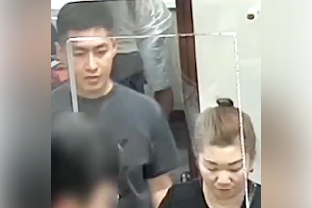 <p>Roy Wang (left) and Qiuju Wu are seen on surveillance footage at a New York bank. The pair have been accused of stealing $2.8 million from a missing Long Island couple's bank account</p>