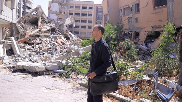 <p>Ahmed Kamal Junina stands in front of what had been his office at Al Aqsa University: ‘This is what the start of the academic year has become in Gaza: education reduced to fragments’</p>