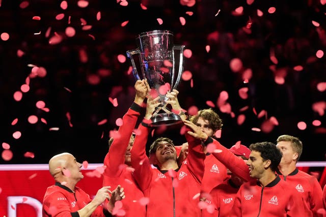 Team World’s Taylor Fritz, of the United States, middle, and teammates raise the Laver Cup Trophy after Team World defeated Team Europe on the third day to win the Laver Cup tennis tournament in San Francisco, Sunday, Sept. 21, 2025. (AP Photo/Jeff Chiu)