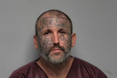 Tattoo-covered suspect accused of murdering mom and daughter served time for killing man and stuffing body in suitcase