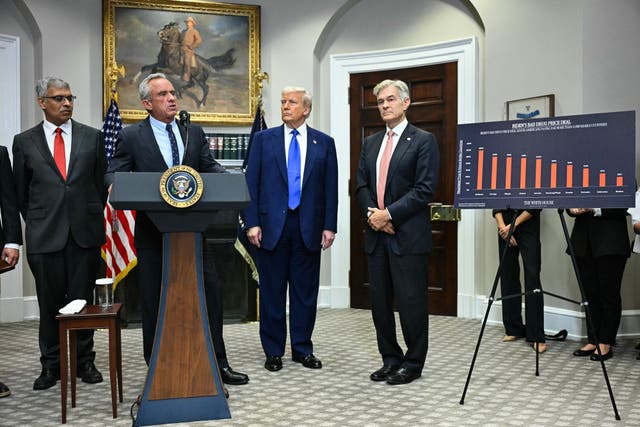 <p>U.S. health secretary Robert F. Kennedy Jr stands in the White House with Donald Trump and other officials as they announce new measures to cut prescription drug prices in May 2025</p>