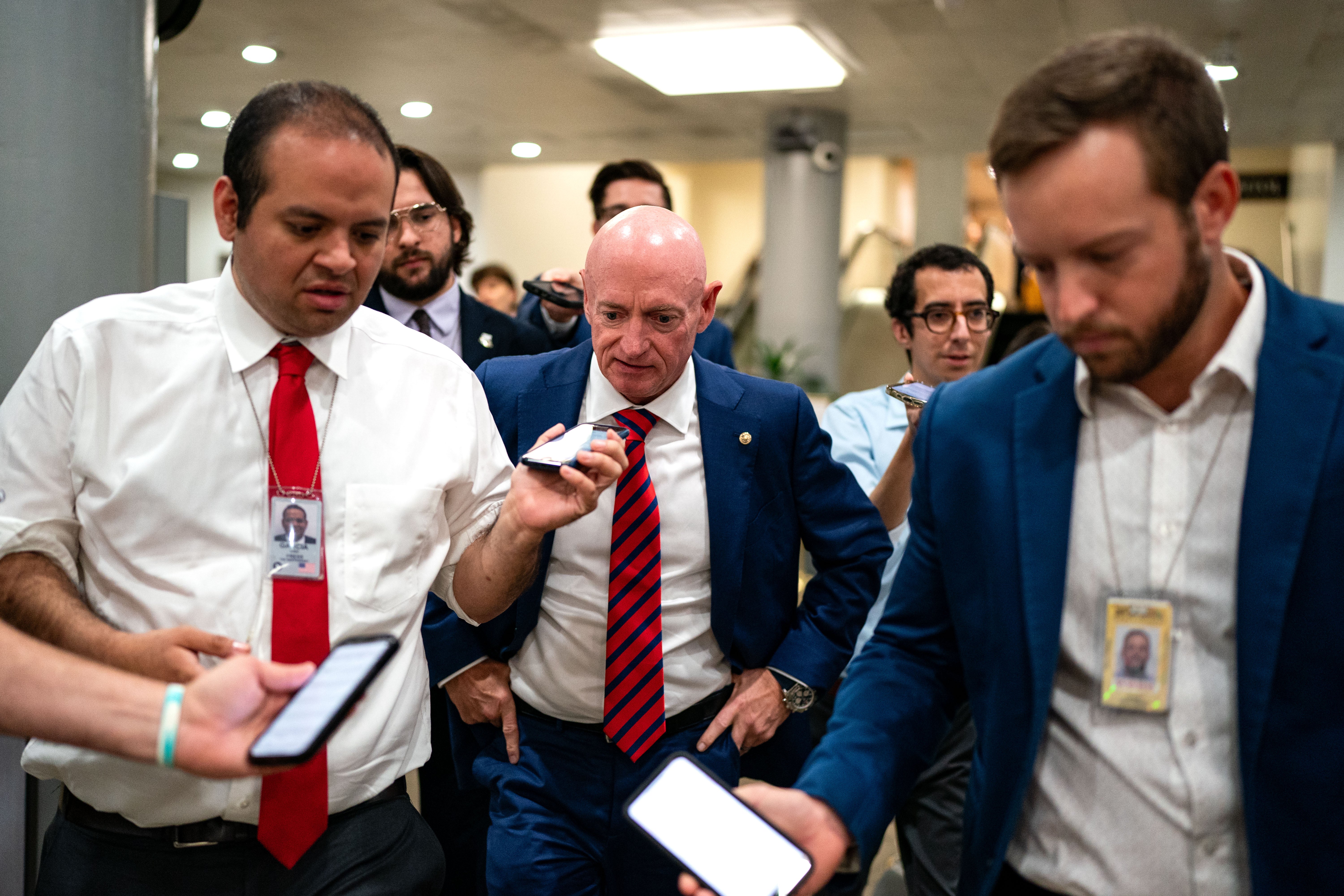The author of this piece (L) questioning U.S. Sen. Mark Kelly (D-AZ) last year, reflects on his fortune to have been diagnosed with ASD in the 1990s. Parents and kids today, he writes, face peril from RFK Jr. and Trump’s autism assumptions