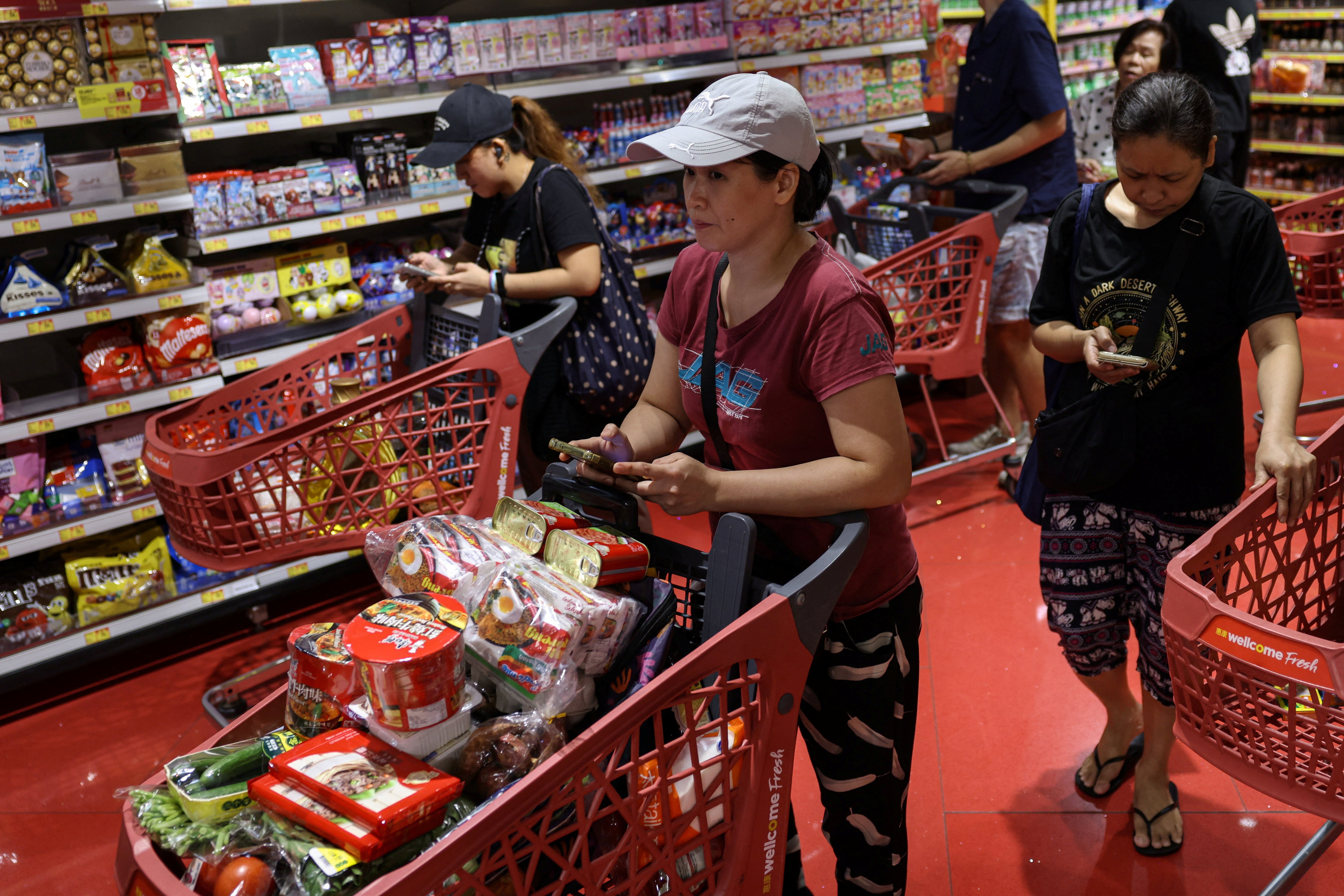 Residents stock up on supplies at a supermarket to prepare for the approaching Typhoon Ragasa, in Hong Kong