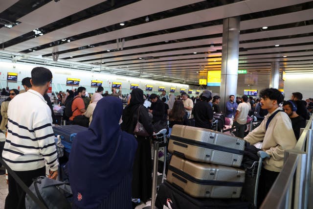 <p>Travellers queue to check in at Heathrow Terminal 4</p>