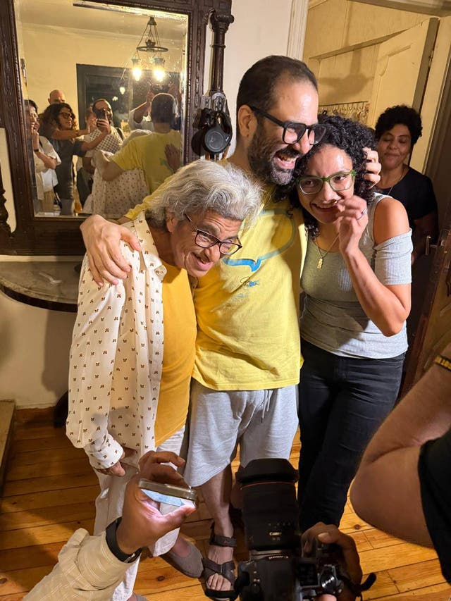 <p>Alaa embraces his mother Laila and sister Sanaa after more than a decade behind bars</p>