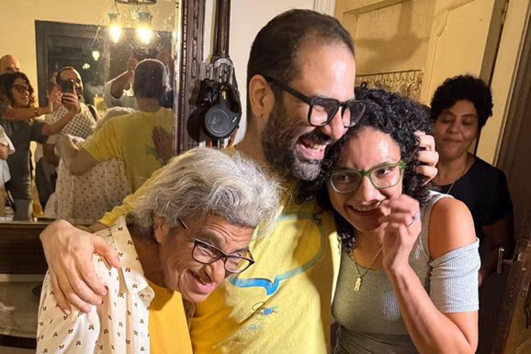 Alaa Abd el-Fattah embraces his mother Laila and sister Sanaa after more than a decade behind bars
