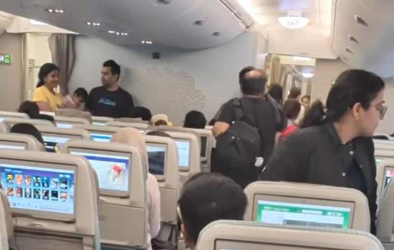 Video shows Emirates passengers preparing to disembark a plane from San Francisco to Dubai after President Donald Trump's H-1B visa application fee announcement sparked confusion.