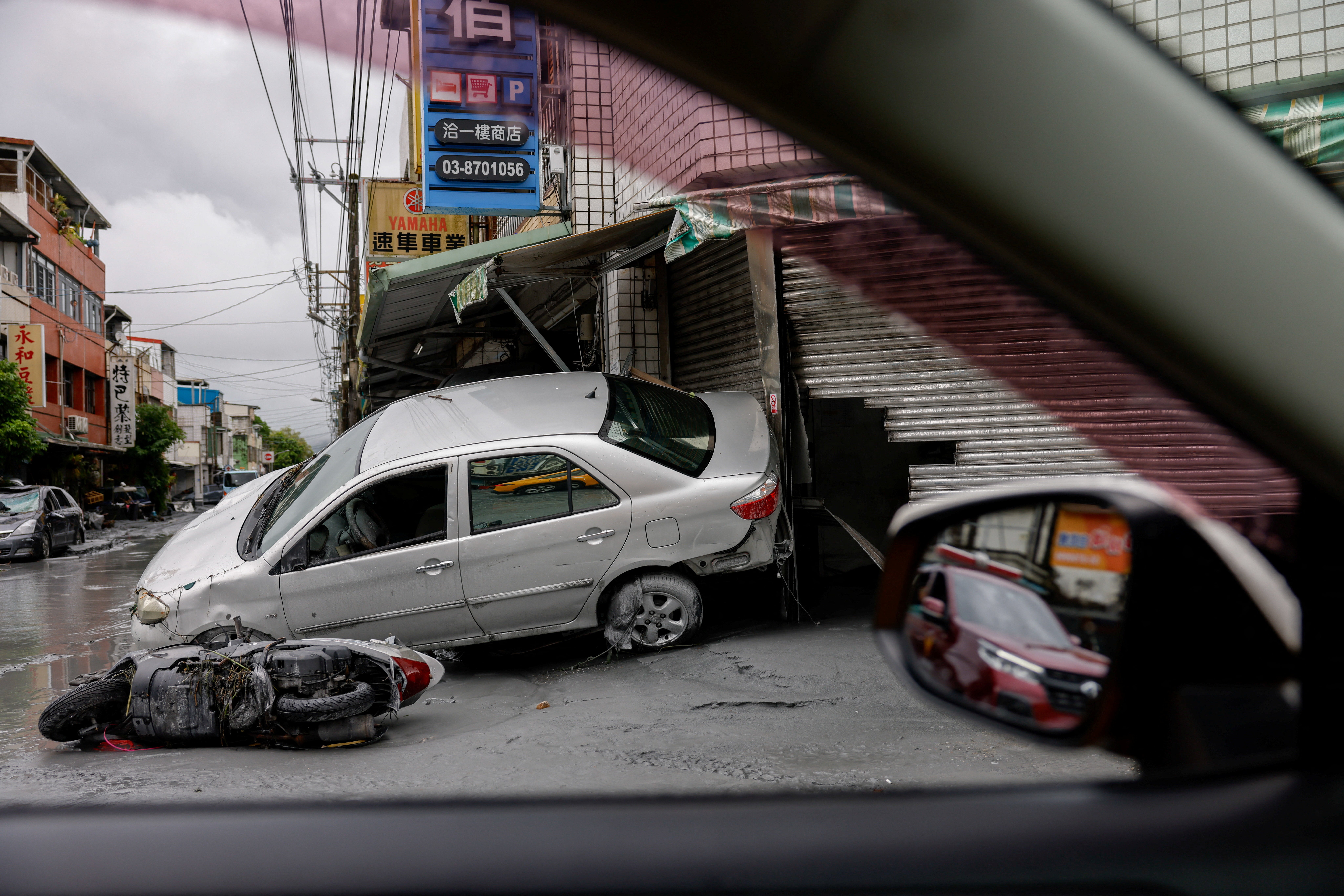 Damaged cars lie, following flooding brought by Super Typhoon Ragasa in Hualien, Taiwan