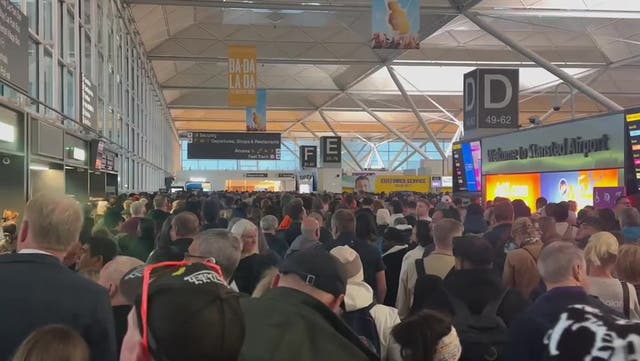 <p>Alarm call: Passengers caught up in the disruption at Stansted airport in Essex</p>