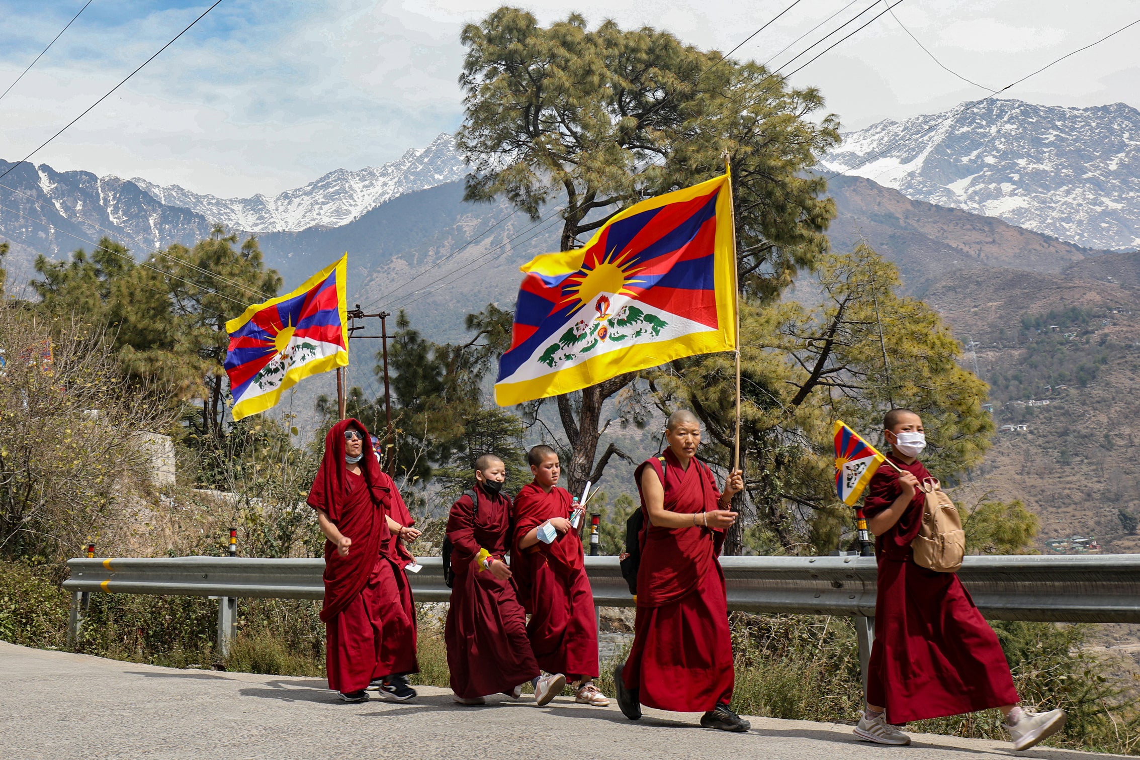 File: Tibetan monks living in exile in India hold Tibet's flags during a peace march on the occasion of 65th Tibetan National Uprising Day against the Chinese occupation of Tibet, in the suburb of McLeod Ganj near Dharamsala on March 10, 2024
