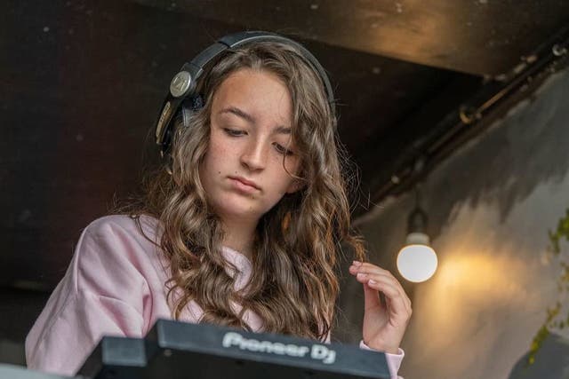 DJ Ellie Long practising skills she honed at The Loft in Dublin’s Tallaght Library (Alan Long/PA)