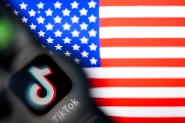 <p>TikTok's logo on a smartphone screen and a US flag illustration on a laptop screen in Frankfurt am Main, western Germany on 10 April, 2025 </p>