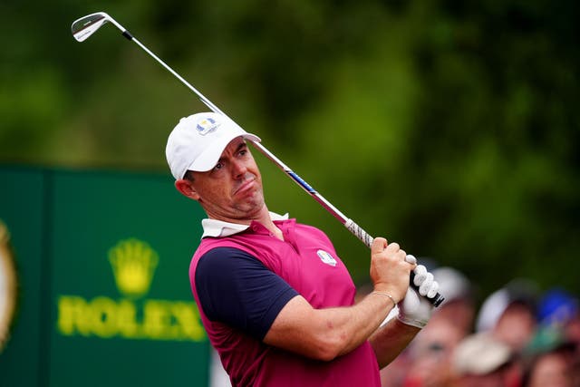 <p>Rory McIlroy looks on after hitting an iron shot during practice on Thursday</p>