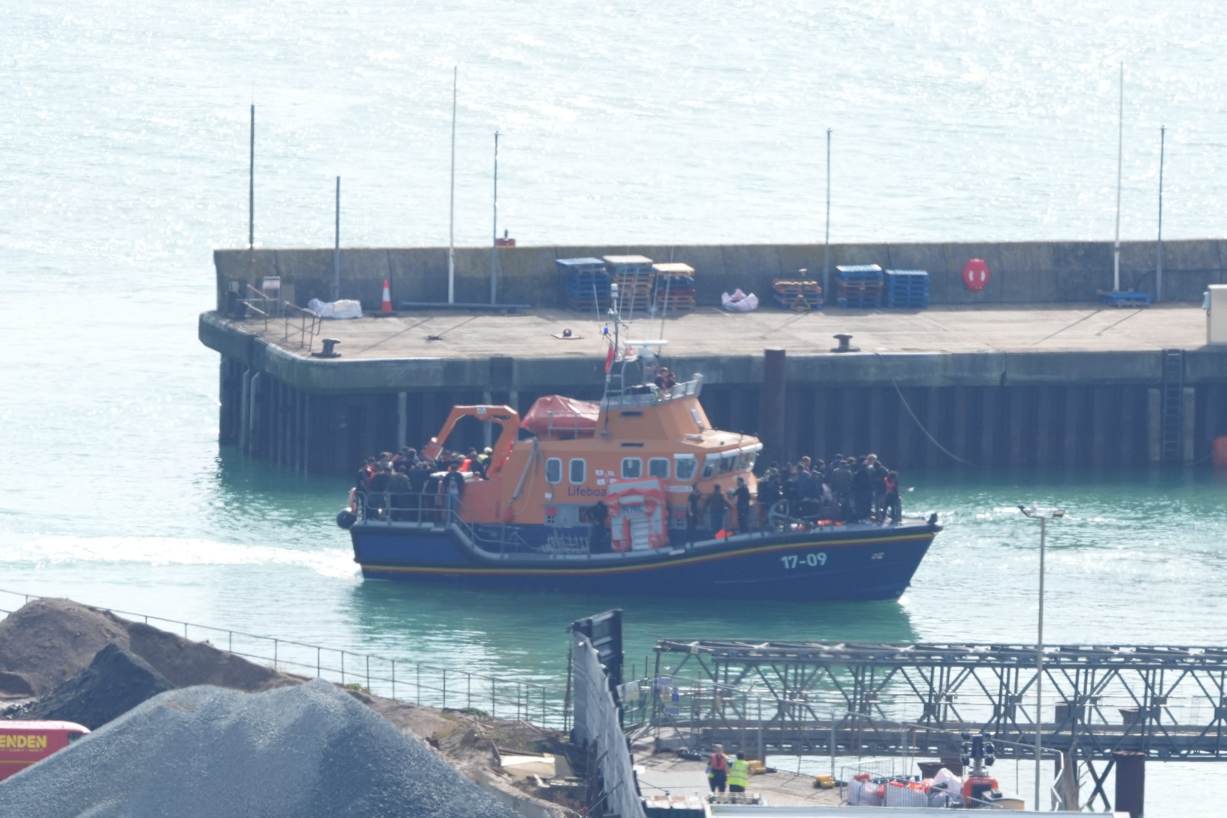 A group of people thought to be migrants are brought into the Dover Border Force compound earlier in September (Jonathan Brady/PA)
