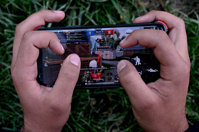 <p>File. Boy playing PUBG on his mobile phone</p>