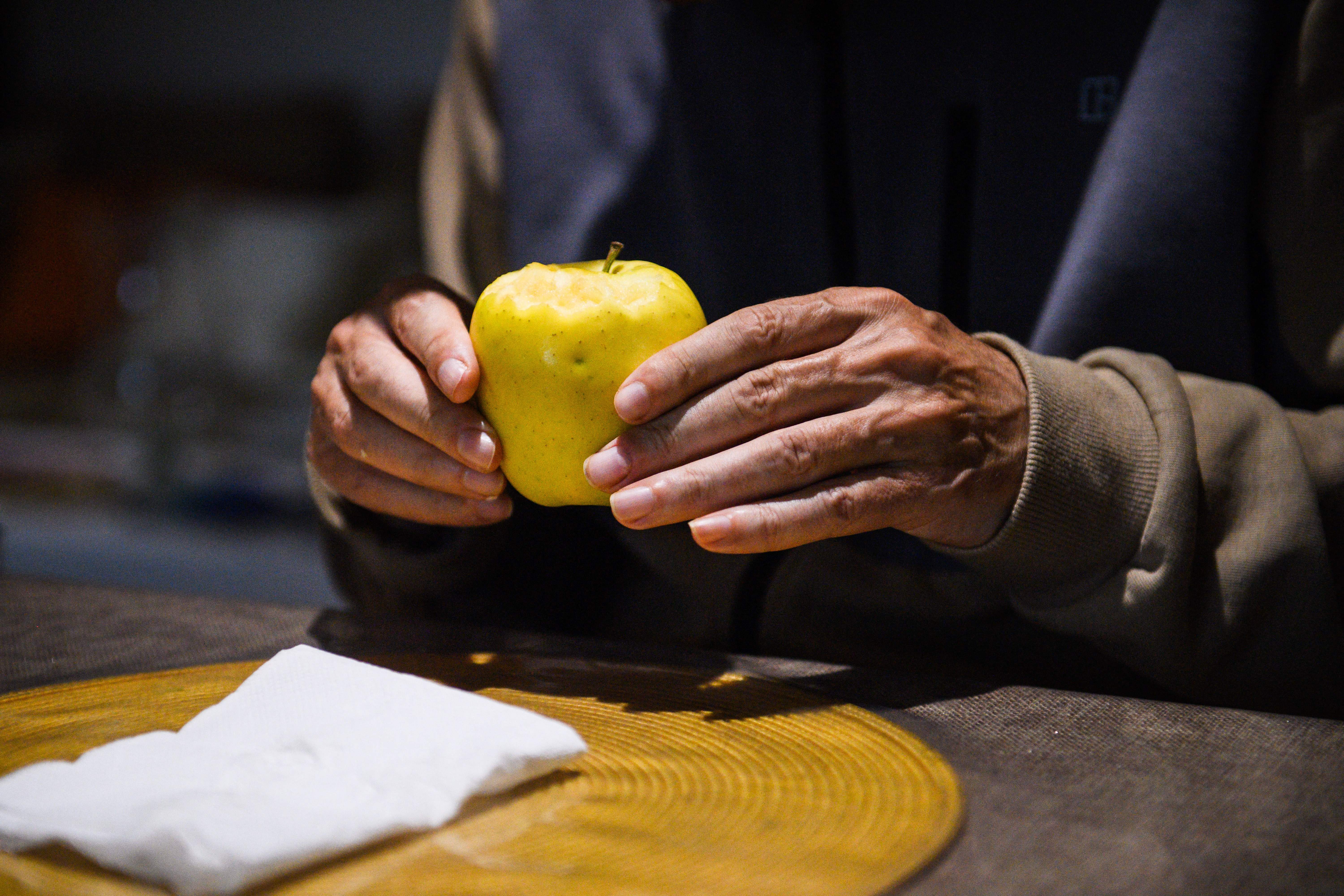 Alzheimer's patient Jean-Marie holds an apple at 