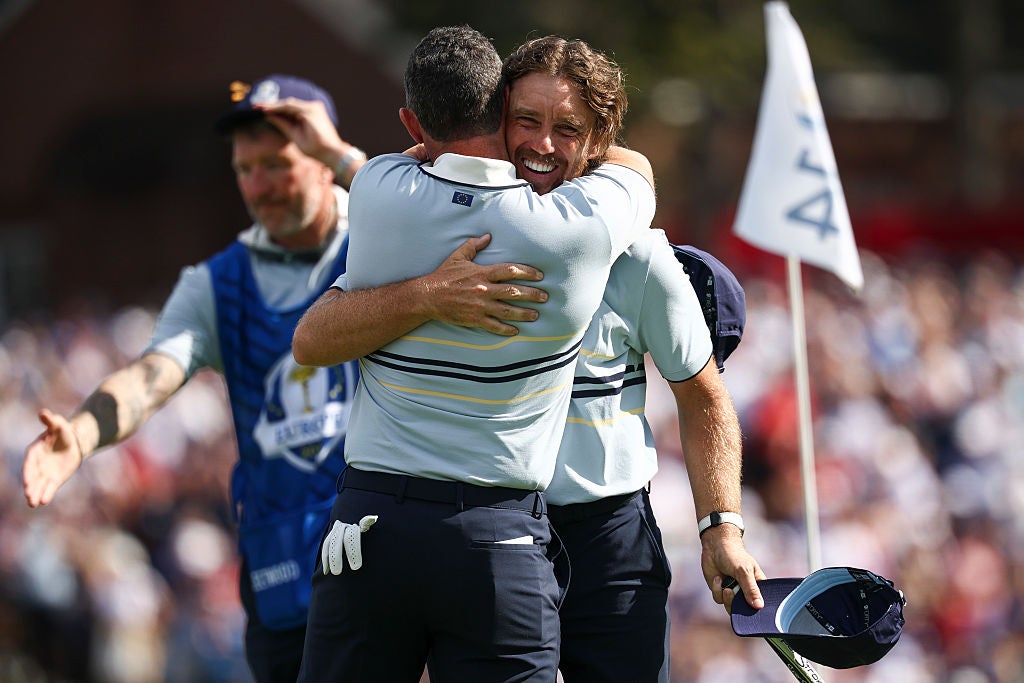 McIlroy and Fleetwood embrace on the 14th green