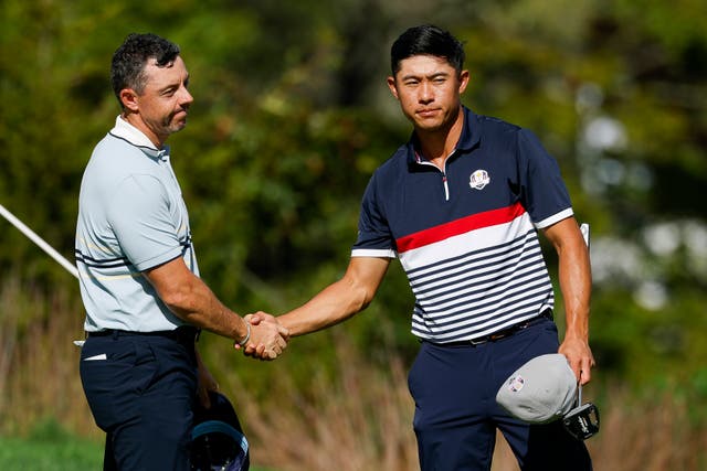 <p>Rory McIlroy of Team Europe shakes hands with Collin Morikawa of Team United States</p>