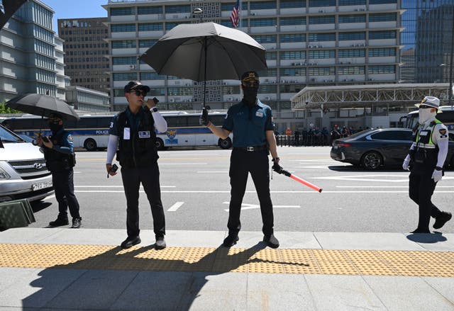 <p>Police officers stand guard against in South Korea</p>