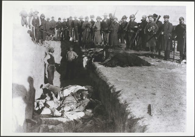 <p>The bodies of Lakota Sioux being unceremoniously piled into a mass grave after the massacre at Wounded Knee, South Dakota, in late December 1890</p>