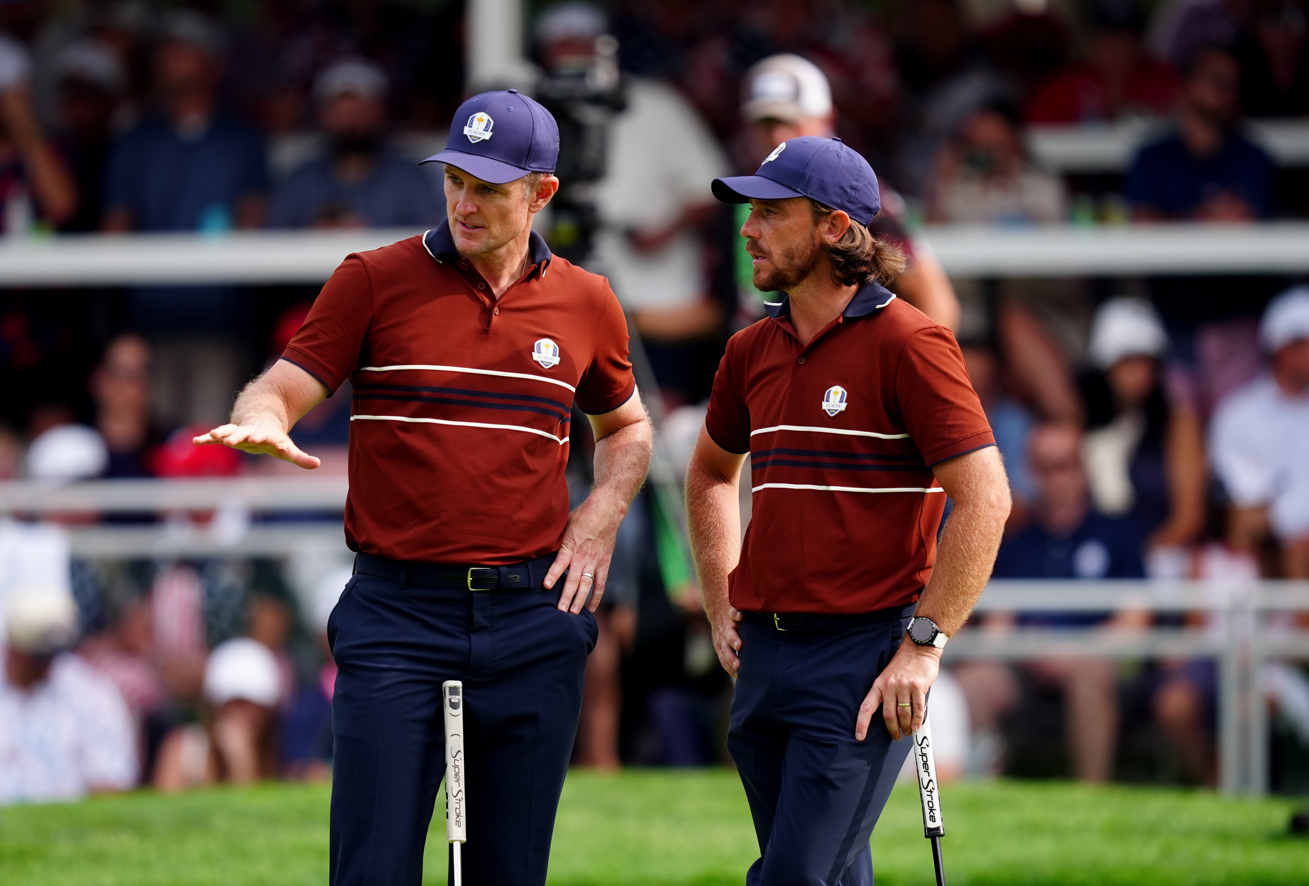 Rose and Fleetwood discuss a putt during the Saturday foursomes