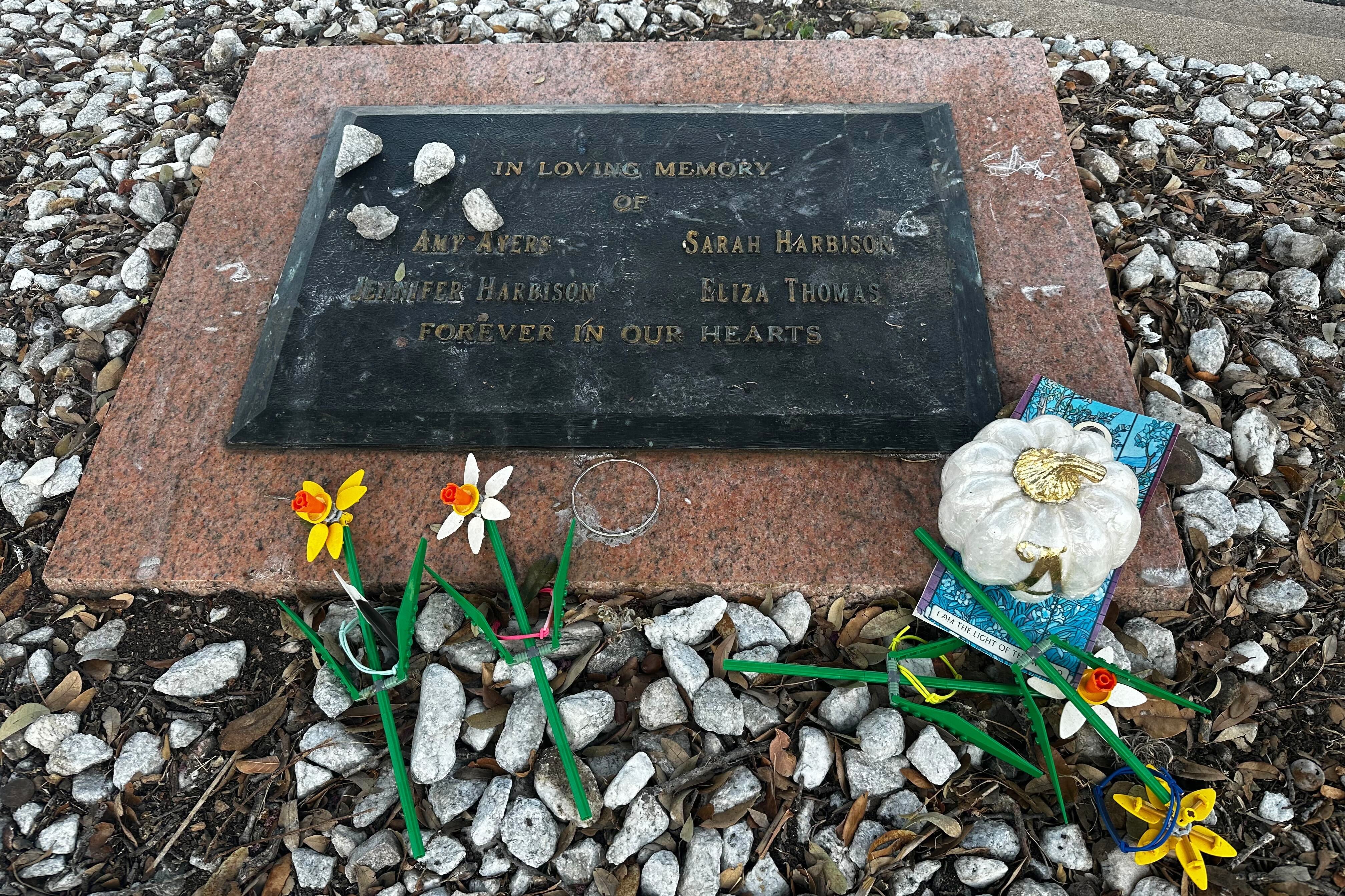 Tributes lay on a memorial Friday, Sept. 26, 2025, for four teenage girls who were killed in a yogurt shop in 1991 in Austin, Texas