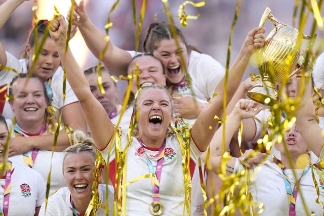 England’s players celebrate as Zoe Aldcroft lifts the Women’s Rugby World trophy (Andrew Matthews/PA)