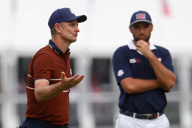 <p>Justin Rose celebrates on the 15th green as Scottie Scheffler looks on</p>