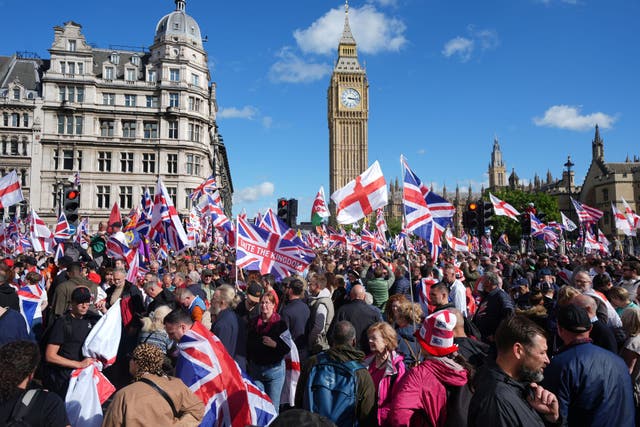 <p>People taking part in a Tommy Robinson-led Unite the Kingdom march and rally in Parliament Square, central London on September 13</p>