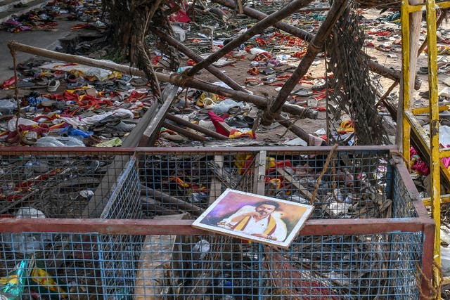 <p>A portrait of actor-turned-politician Vijay is seen near the scattered shoes after a stampede that broke out last evening during his political rally in the Karur district, in the Indian state of Tamil Nadu, on 28 September 2025</p>