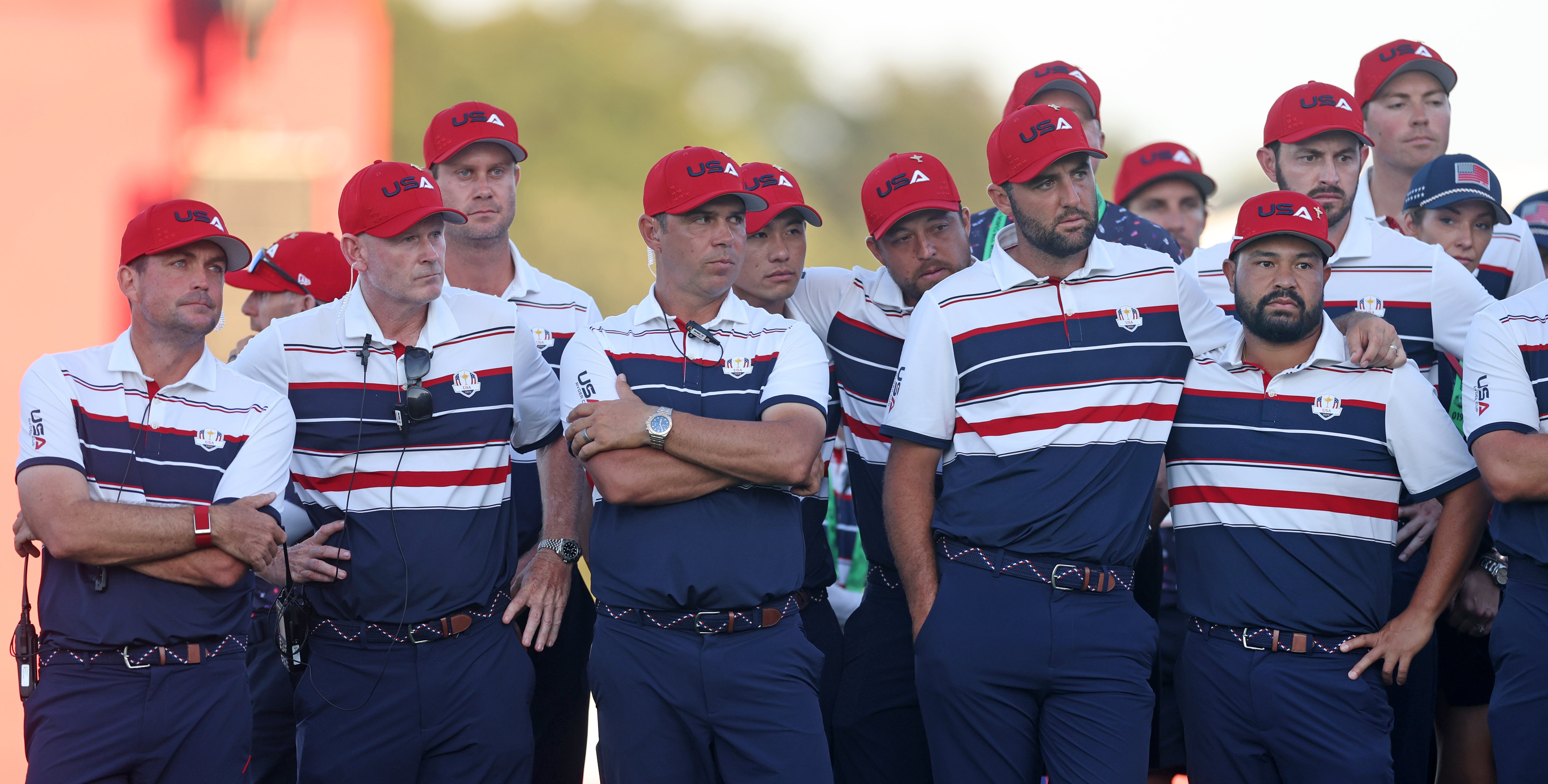Captain Keegan Bradley and members of Team United States stand together on the 18th green after being defeated