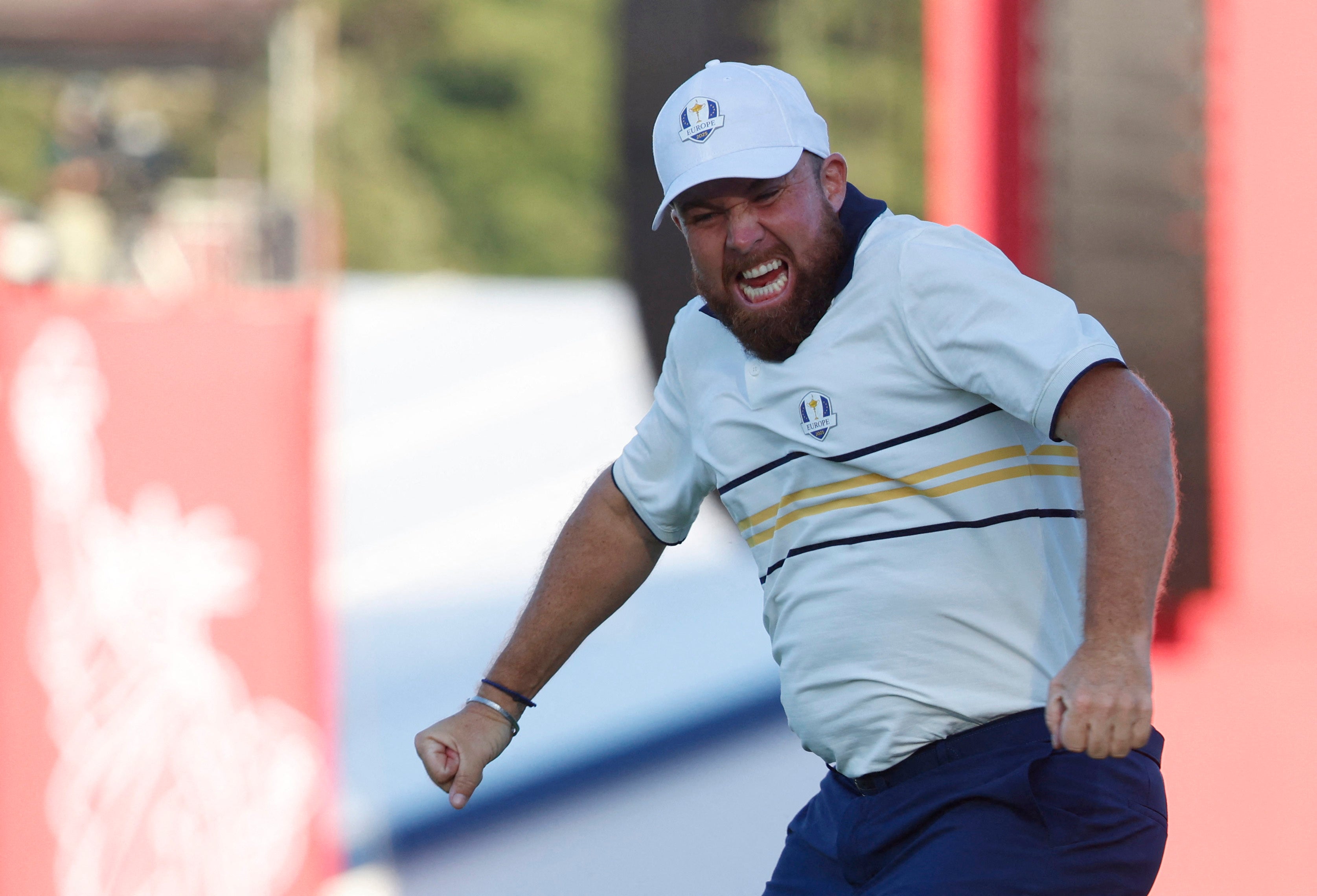 Team Europe's Shane Lowry celebrates holing his putt to halve his match on the 18th hole during the singles match to retain the Ryder Cup