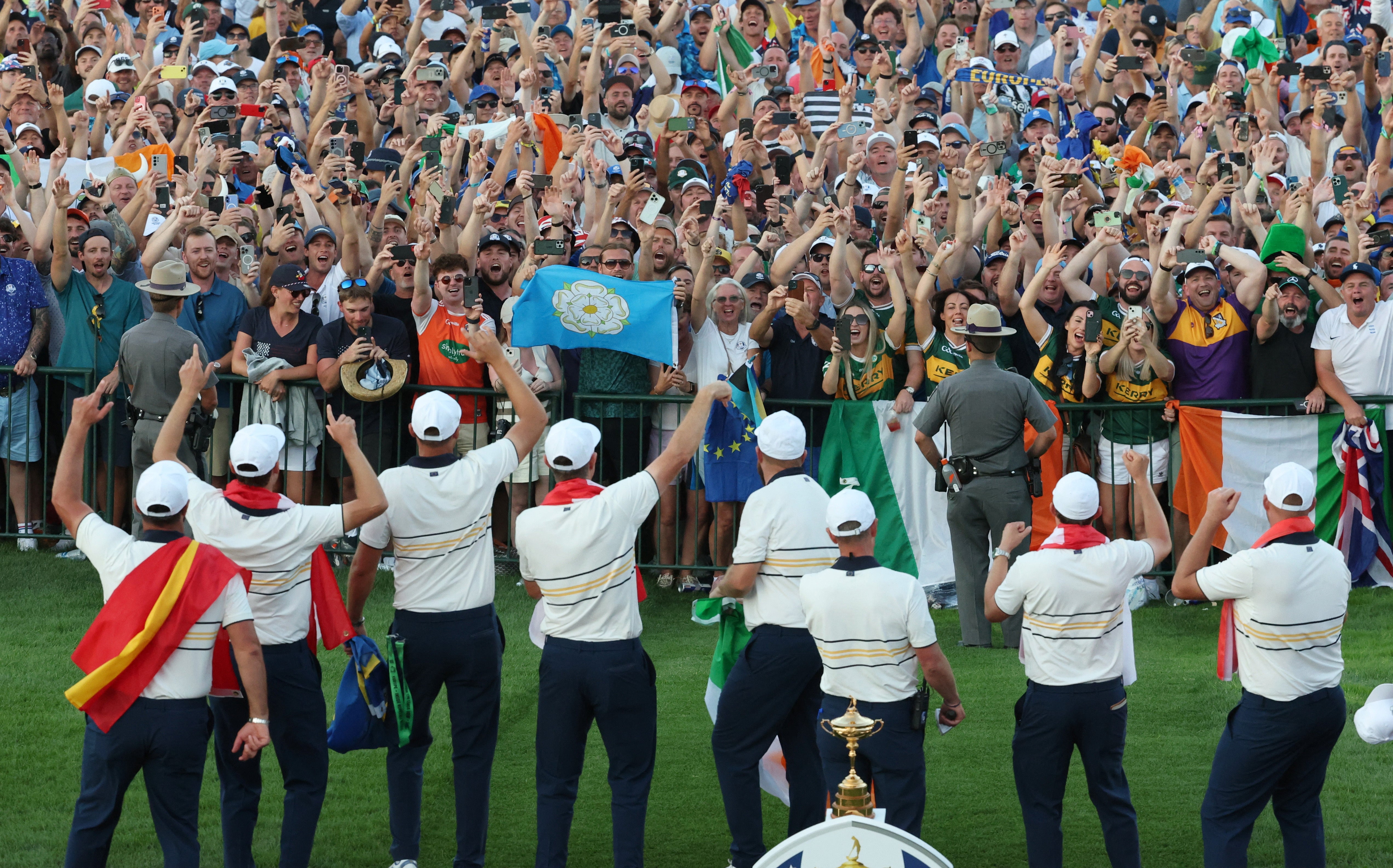 Team Europe celebrates winning the Ryder Cup in front of fans before the trophy presentation