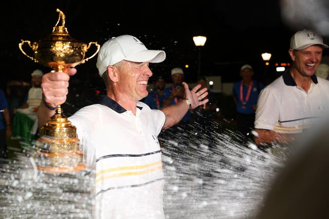 <p>Captain Luke Donald of Team Europe holds the Ryder Cup trophy</p>