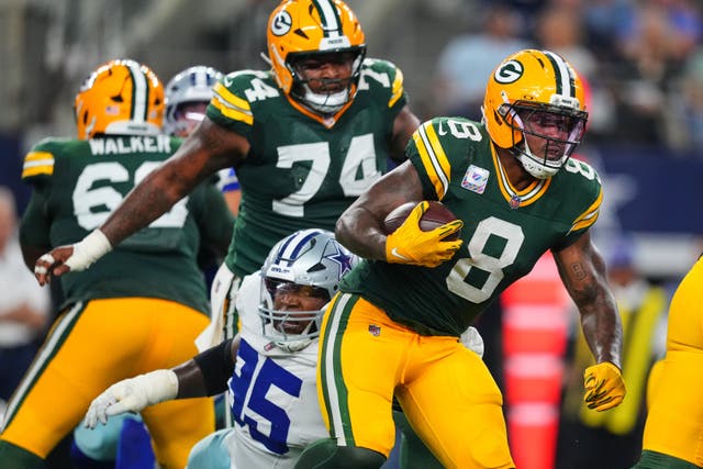 Green Bay Packers’ Josh Jacobs (8) gets past Dallas Cowboys defensive tackle Kenny Clark (95) (Julio Cortez/AP)